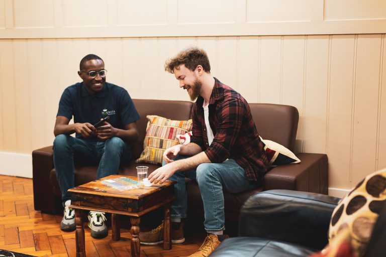 Counsellor and service user talking on a sofa